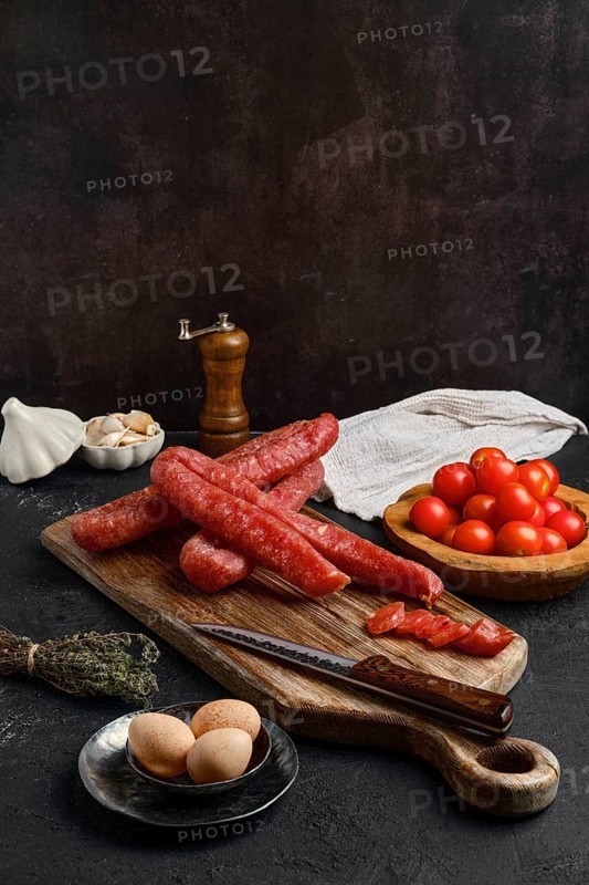 Air dried turkey sausage. Rustic lunch with eggs and tomato