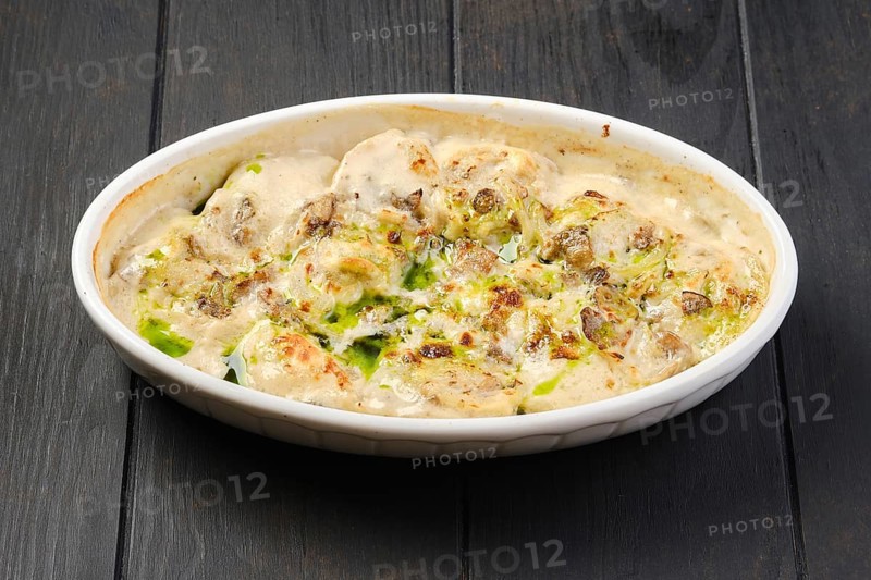 Chicken dumplings with spicy onion sauce baked in oven