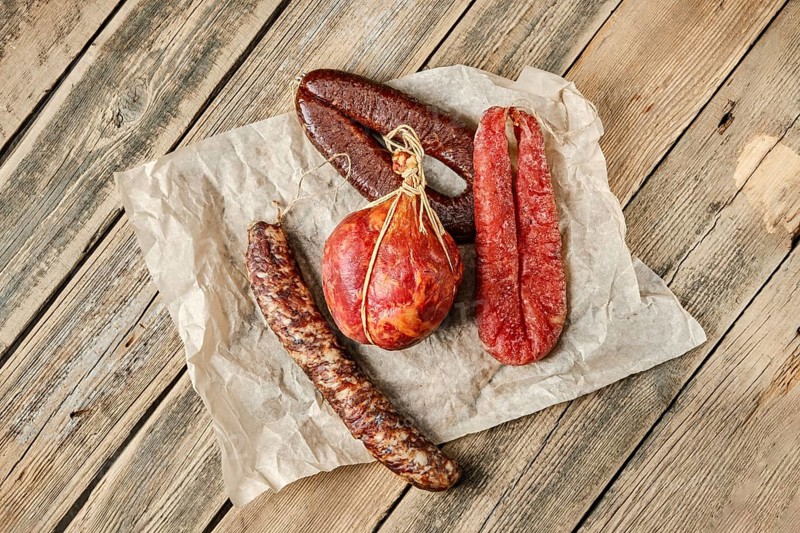 Top view of smoked dried sausages on wrapping paper