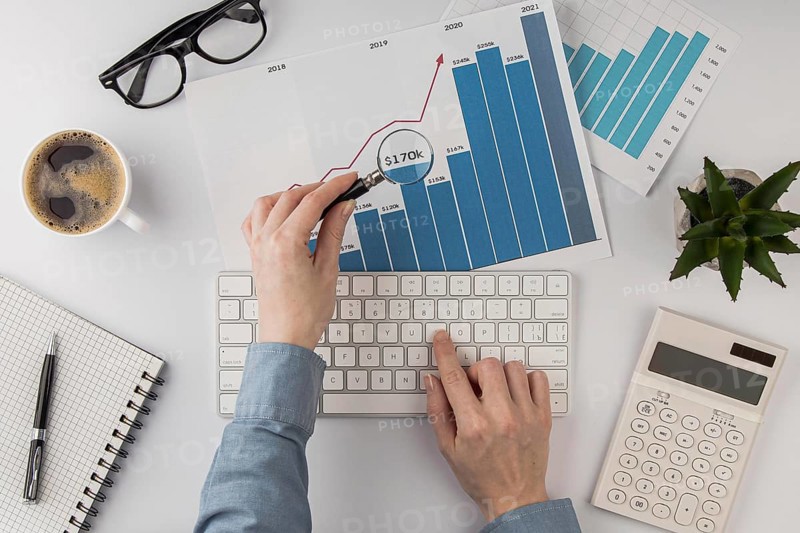 Top view office desk with growth chart analyzed with magnifying glass. Resolution and high quality beautiful photo