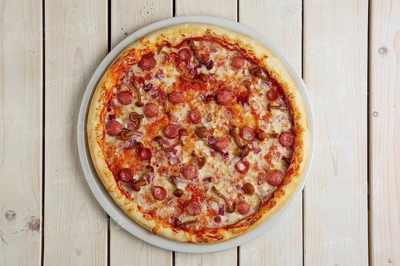 Top view of pizza with sausage and honey agaric