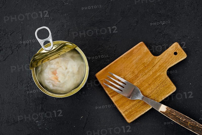 Top view of canned crab meat in open jar