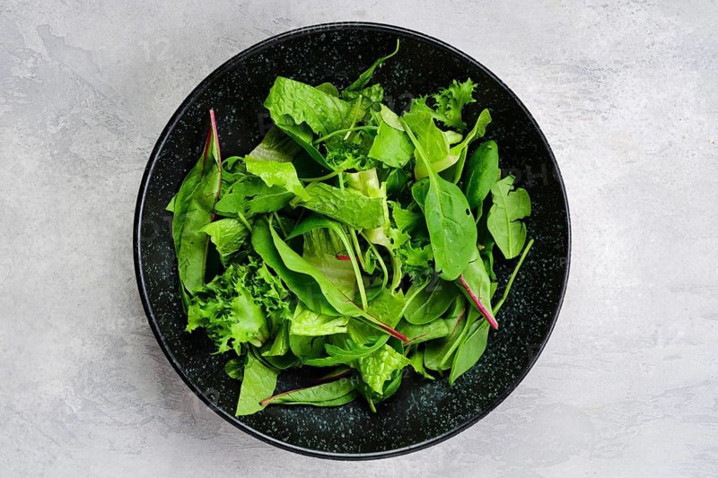 Top view of plate with assortment of fresh salad leaves