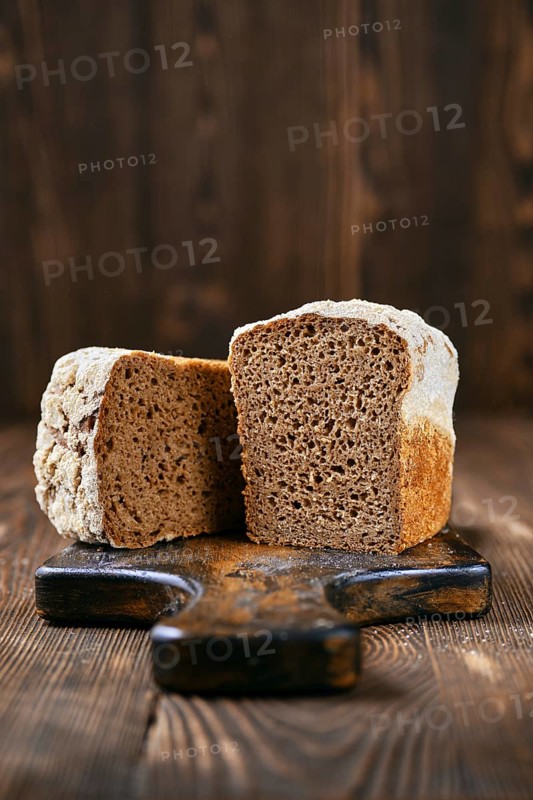 Loaf of artisan rye bread cut on half