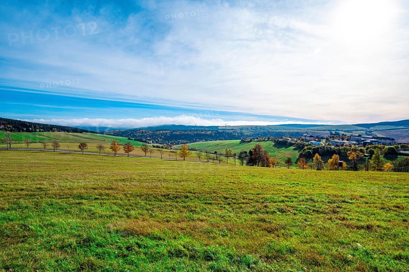 A meadow at the foot of the Fichtelberg with a view into the valley in autumn
