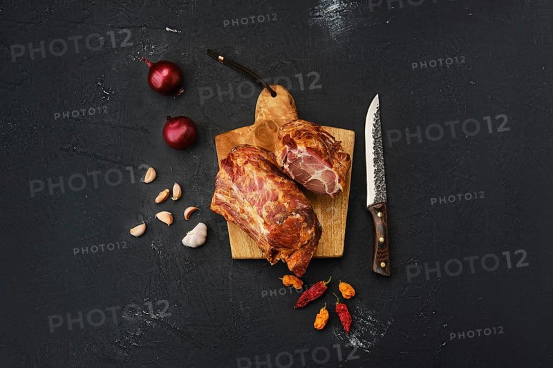 Air dried lamb neck meat on wooden cutting board