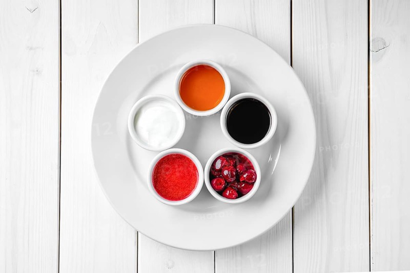 Assortment of different sauce on white wooden table