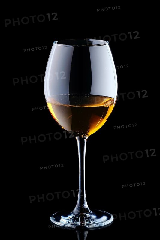 Glass with white wine isolated on black background