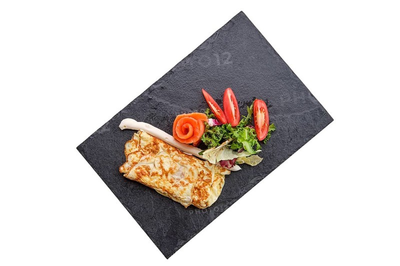 Omelette with salmon isolated on white