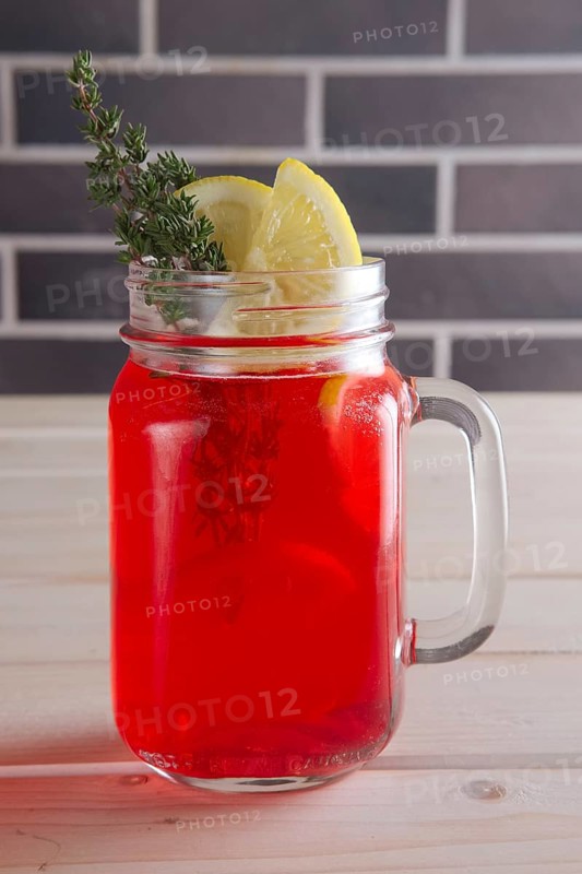 Cup of cranberry juice with citrus and rosemary
