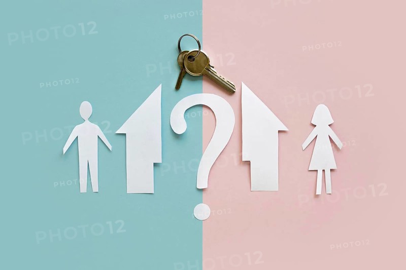 Flat lay paper family house separated with key