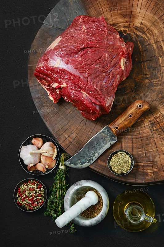 Top view of raw beef neck with thyme