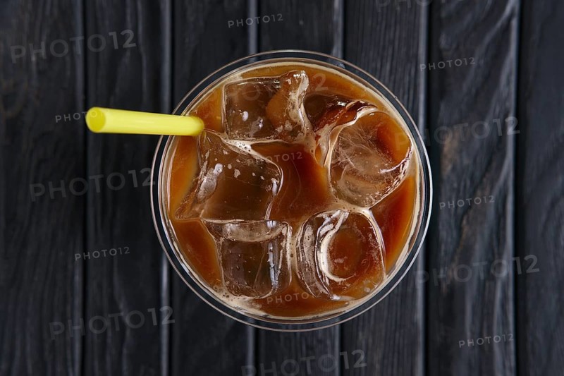 Top view of ice coffee drink with straw