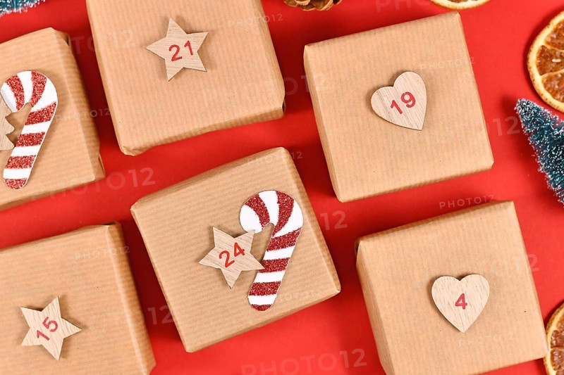 Homemade Advent calendar made from craft paper boxes on red background