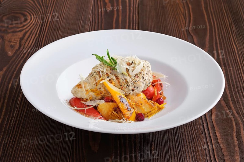 Fried turkey meat with roasted tomato and bell pepper served with parmesan