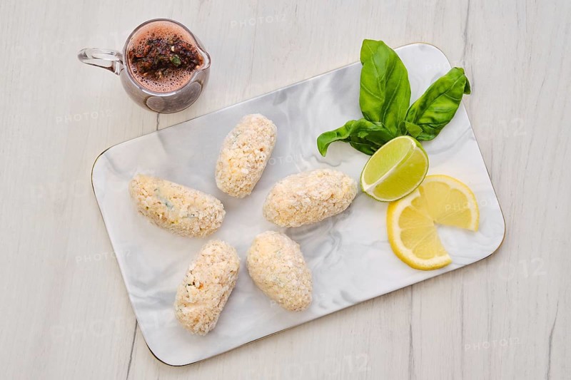 Top view of brown salmon meat cutlet in cheese breading