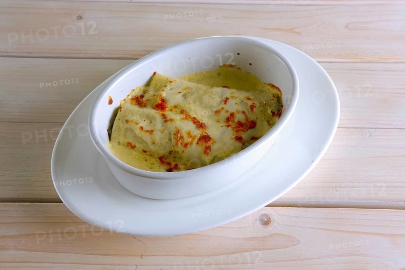 Thin pancakes stuffed with meat and covered with melted cheese