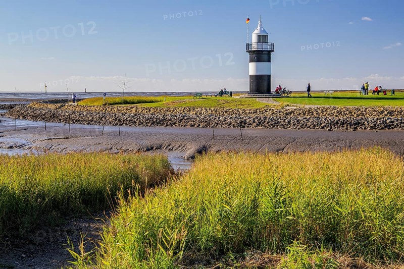 Tidal creek with lighthouse Kleiner Preusse on the Wadden Sea at the mouth of the Weser