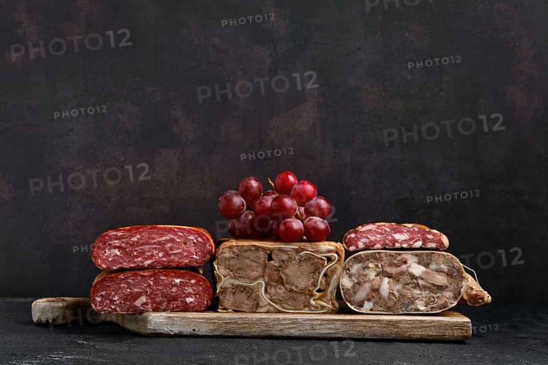 Wooden cutting board with boiled pork meat roll