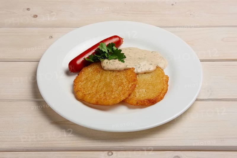 Portion of potato frlapjack with smoked sausage and mustard sauce