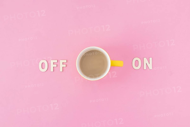 Coffee cup near off writings