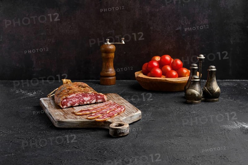 Homemade smoked pork sausage in organic casing on wooden cutting board