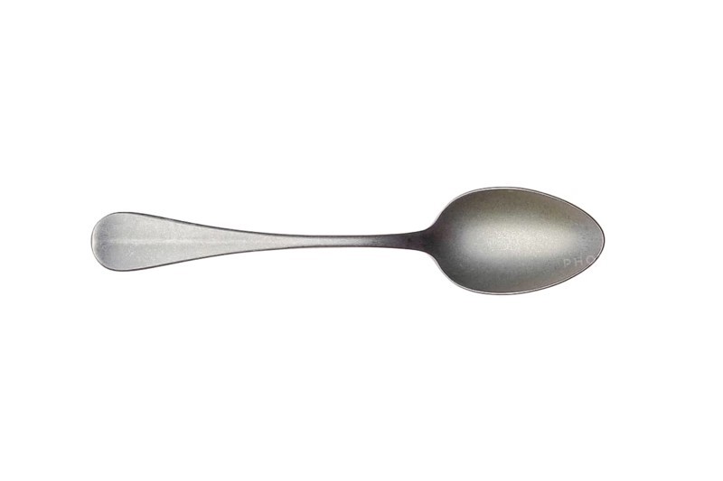 Vintage metal tea spoon isolated on white background