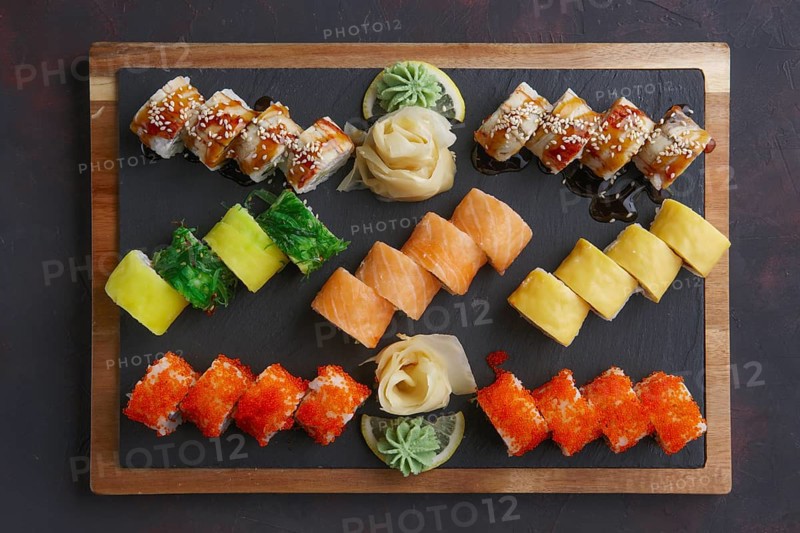 Top view of big set of rolls served on stone plate