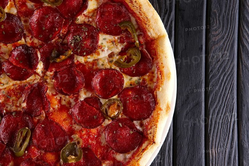 Hot pizza pepperoni with jalapeno pepper. Top view