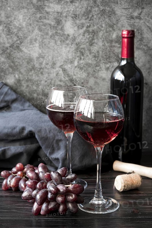 Front view bottle wine with grapes