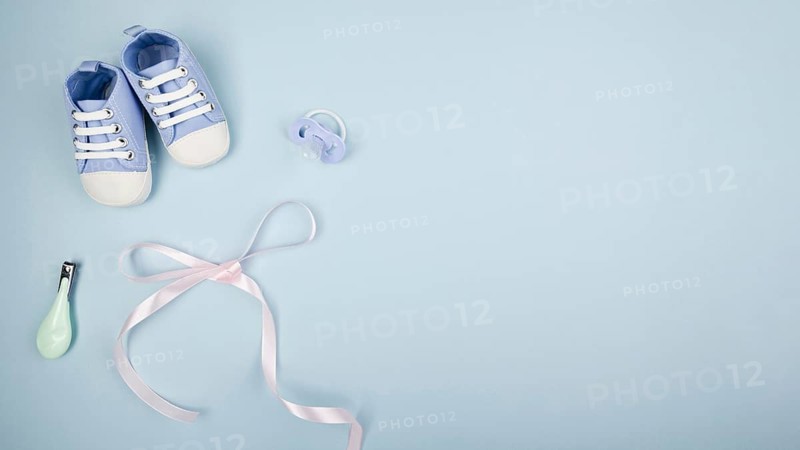 Ribbon with baby shoes copy space