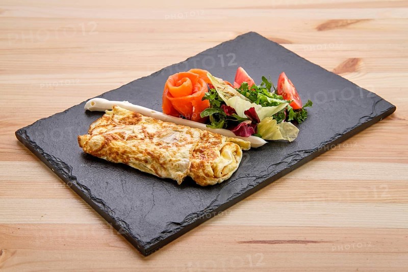 Omelette with salmon on slate plate