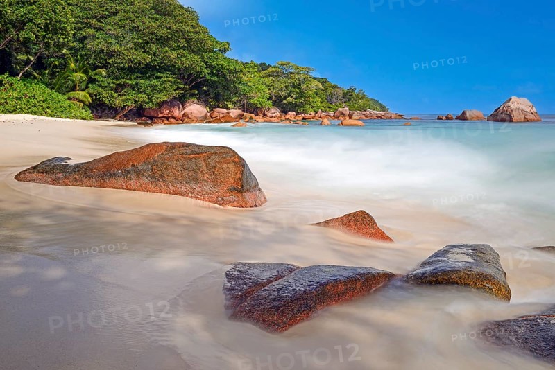 Beach and rocks of Anse Lazio in the evening