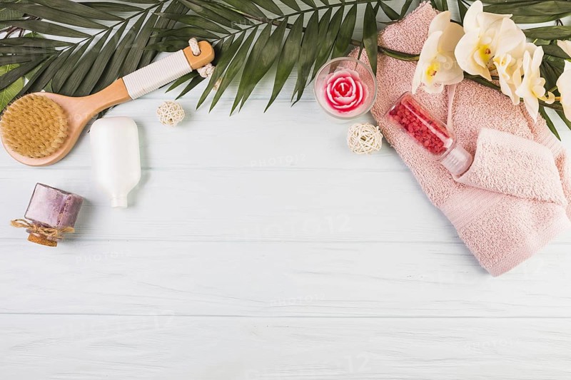 Towel salt bottle brush flowers leaves wooden background. Resolution and high quality beautiful photo