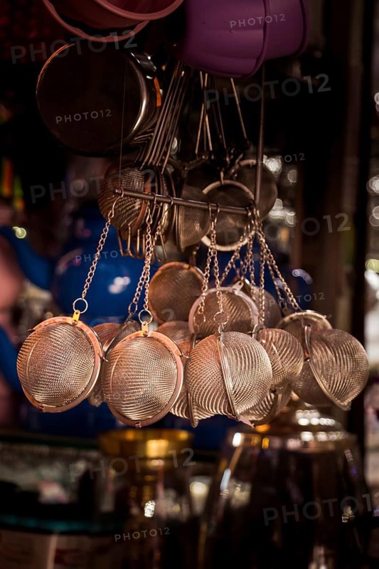 Group of metal strainers hanging in the view