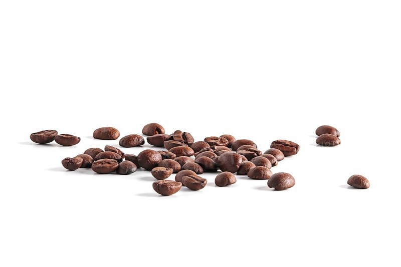 Coffee beans scattered on white background
