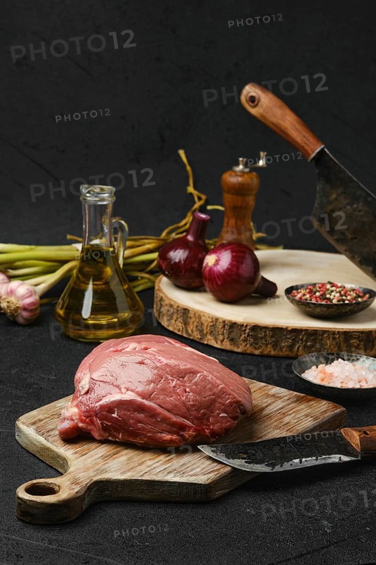 Raw beef petite sirloin with ingredients on black background