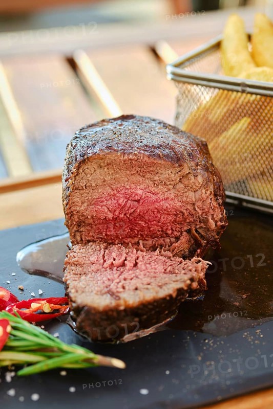 Grilled big fillet mignon beef steak cut on half