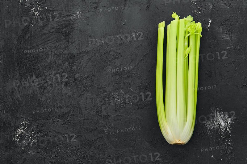 Fresh raw celery on black background