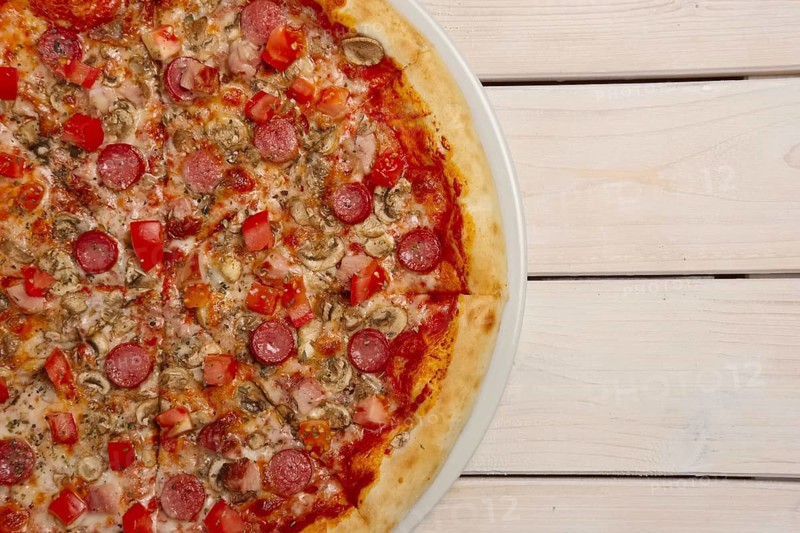 Top view of pizza pepperoni on wooden table