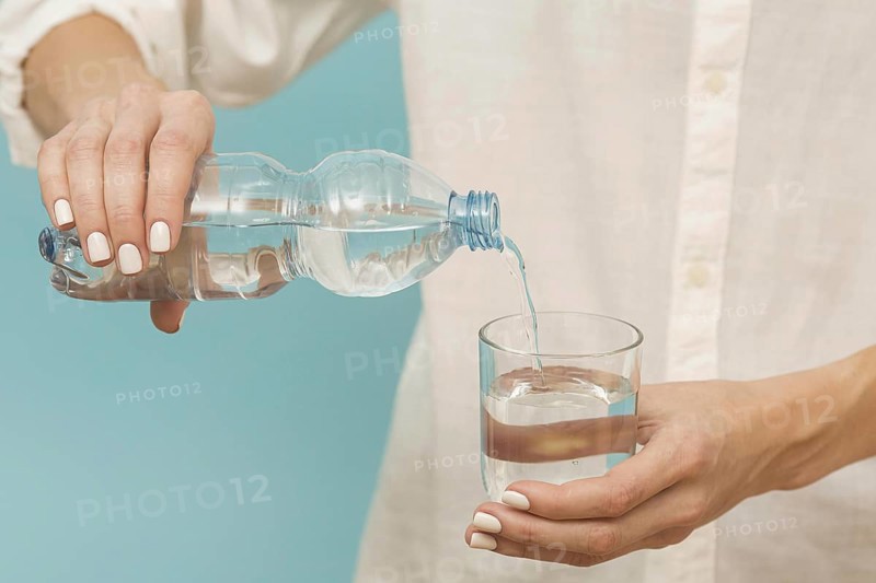 Woman pouring water into glass. Resolution and high quality beautiful photo
