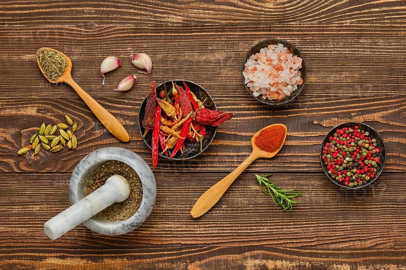 Overhead composition with spicy spice and seasonings on wooden background