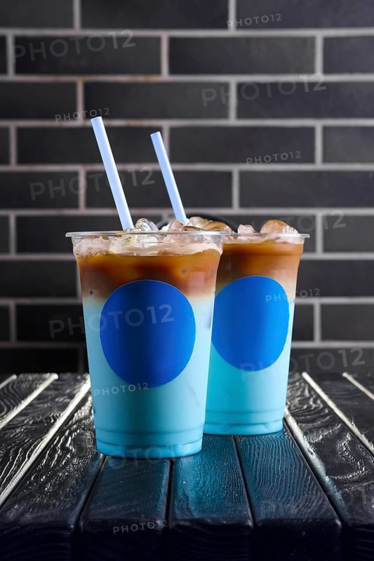 Concept of blue coffee cocktail. Plastic take away cup of blue ice drink