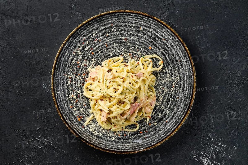 Overhead view of pasta with bacon and ham