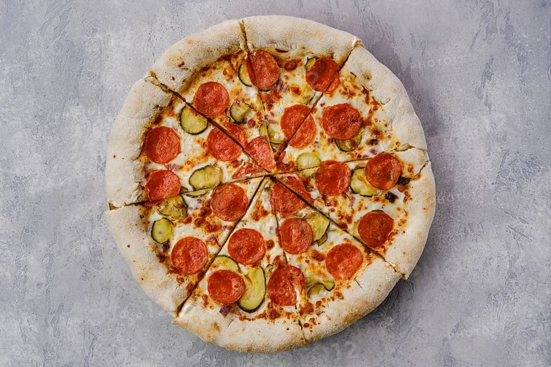 Top view of pizza pepperoni with cheese crust on wooden table