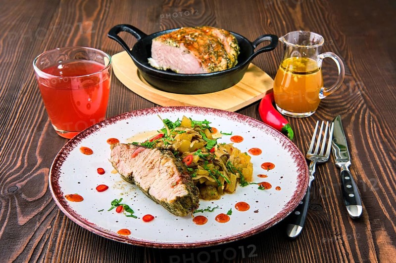 Oven-baked meat with braised cabbage and zucchini and hot spicy sauce