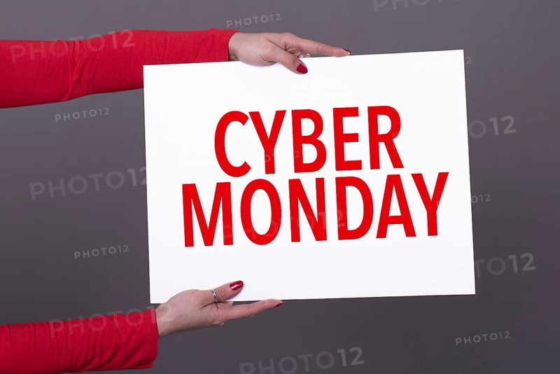Female hands holding a cyber monday poster. Studio shot