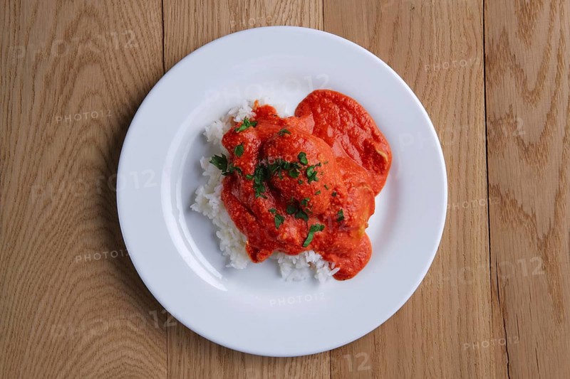 Top view of meatballs with rice on wooden table on wooden table