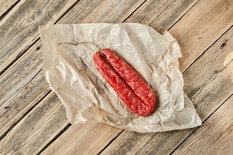 Top view of smoked dried turkey sausage on wrapping paper