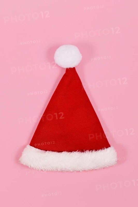 Single red Santa hat on pink background
